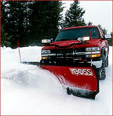 Red truck plowing snow off driveway